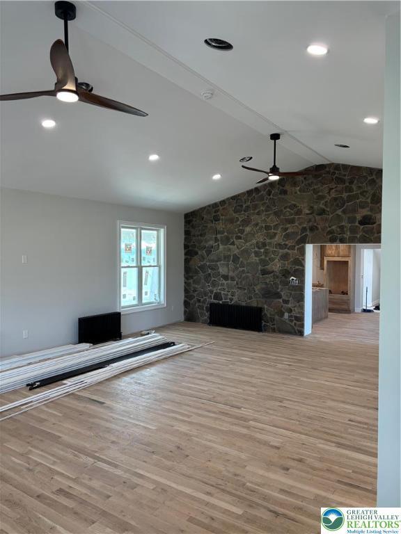 1028 Washington Blvd, Washington Twp, PA 18013 - unfurnished living room with ceiling fan, a fireplace, light wood-style flooring, and lofted ceiling