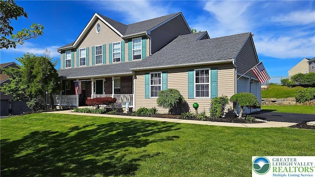 4125 Redbud Dr W, Whitehall Twp, PA 18052 - view of front facade with a porch, a front yard, a garage, and roof with shingles