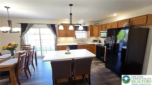 4125 Redbud Dr W, Whitehall Twp, PA 18052 - kitchen with black appliances, a sink, a chandelier, dark wood-style floors, and recessed lighting