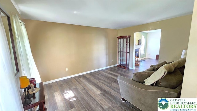 4125 Redbud Dr W, Whitehall Twp, PA 18052 - living room with dark wood-style floors, a glass covered fireplace, and baseboards