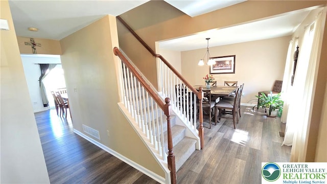 4125 Redbud Dr W, Whitehall Twp, PA 18052 - stairs featuring wood finished floors, a chandelier, and baseboards