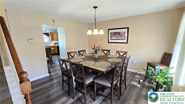 4125 Redbud Dr W, Whitehall Twp, PA 18052 - dining area featuring dark wood finished floors, baseboards, and a chandelier
