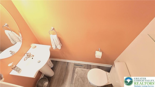 4125 Redbud Dr W, Whitehall Twp, PA 18052 - half bathroom featuring toilet and wood finished floors