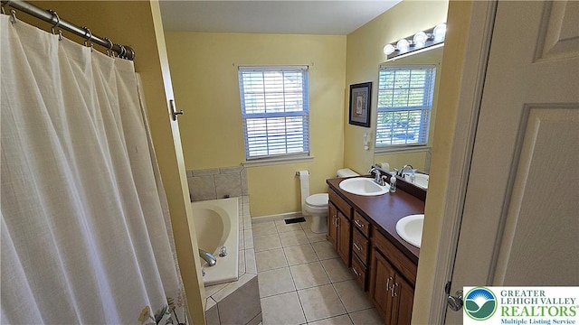 4125 Redbud Dr W, Whitehall Twp, PA 18052 - bathroom with toilet, a bath, double vanity, tile patterned floors, and baseboards