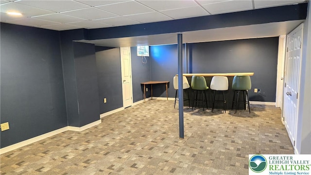 4125 Redbud Dr W, Whitehall Twp, PA 18052 - finished below grade area with a paneled ceiling, a bar, and baseboards
