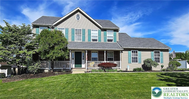 4125 Redbud Dr W, Whitehall Twp, PA 18052 - traditional home with covered porch, a front lawn, and a shingled roof
