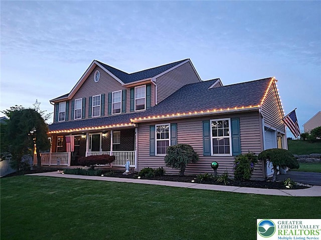 4125 Redbud Dr W, Whitehall Twp, PA 18052 - view of front of house with a porch, a front lawn, a shingled roof, and a garage