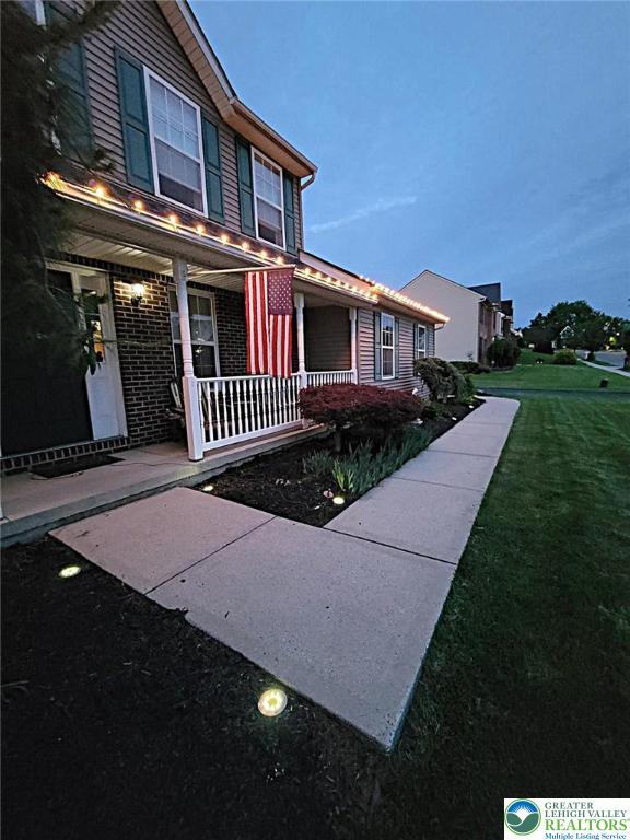 4125 Redbud Dr W, Whitehall Twp, PA 18052 - view of front of home featuring a porch and a front yard