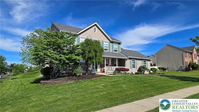 4125 Redbud Dr W, Whitehall Twp, PA 18052 - traditional-style home with covered porch and a front lawn