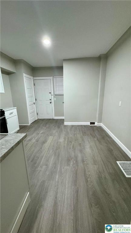 836 Elliger St, Allentown City, PA 18102 - unfurnished living room featuring dark wood finished floors and baseboards