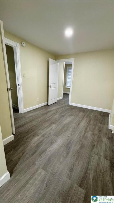 836 Elliger St, Allentown City, PA 18102 - spare room with baseboards, dark wood-style flooring, and a smoke detector