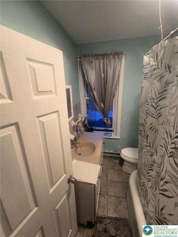 726 N 8th St, Allentown City, PA 18102 - bathroom with vanity, tile patterned flooring, a shower with shower curtain, toilet, and a tub to relax in