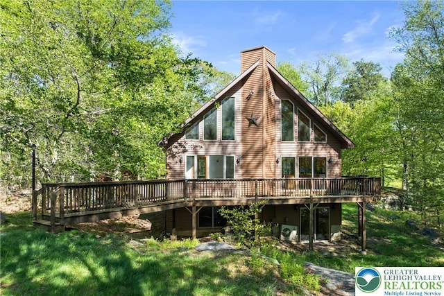 2107 Lenape Ter, Barrett Twp, PA 18325 - rear view of property featuring a wooden deck, a chimney, and a lawn