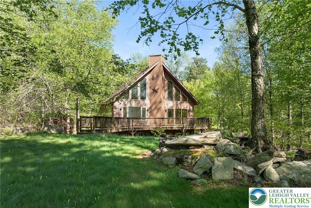 2107 Lenape Ter, Barrett Twp, PA 18325 - view of side of property featuring a chimney, a lawn, and a deck