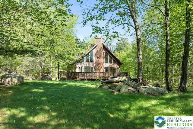2107 Lenape Ter, Barrett Twp, PA 18325 - view of grassy yard featuring a deck