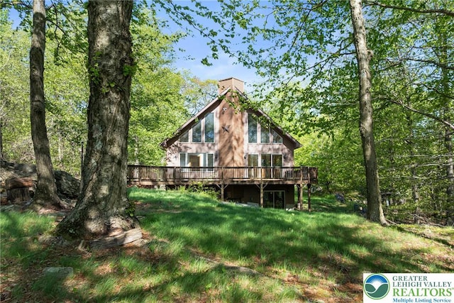 2107 Lenape Ter, Barrett Twp, PA 18325 - back of property featuring a wooden deck and a chimney