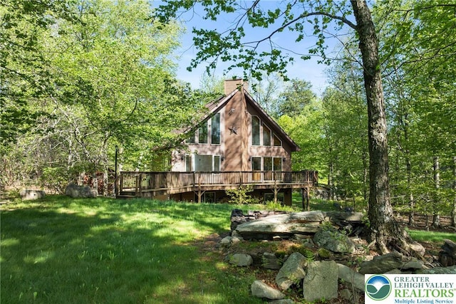 2107 Lenape Ter, Barrett Twp, PA 18325 - back of house featuring a chimney, a deck, and a yard