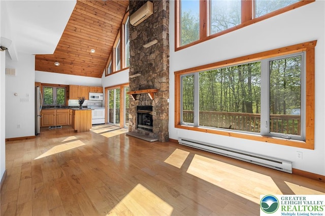 2107 Lenape Ter, Barrett Twp, PA 18325 - unfurnished living room featuring a baseboard heating unit, an AC wall unit, high vaulted ceiling, healthy amount of natural light, and wood ceiling
