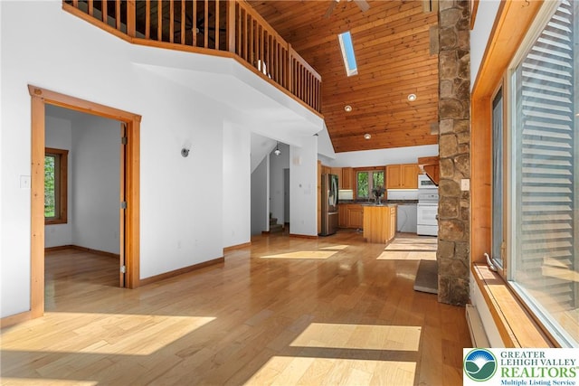 2107 Lenape Ter, Barrett Twp, PA 18325 - unfurnished living room featuring high vaulted ceiling, light wood-style flooring, baseboards, a sink, and wooden ceiling