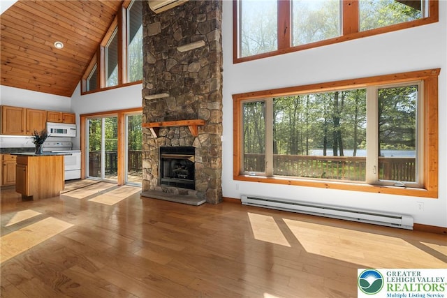 2107 Lenape Ter, Barrett Twp, PA 18325 - unfurnished living room featuring high vaulted ceiling, a baseboard radiator, light wood-style floors, a stone fireplace, and baseboards