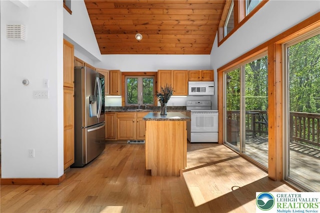 2107 Lenape Ter, Barrett Twp, PA 18325 - kitchen featuring white appliances, a center island, light wood-type flooring, high vaulted ceiling, and a sink