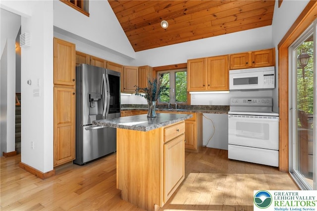 2107 Lenape Ter, Barrett Twp, PA 18325 - kitchen with white appliances, vaulted ceiling, plenty of natural light, dark countertops, and light wood finished floors