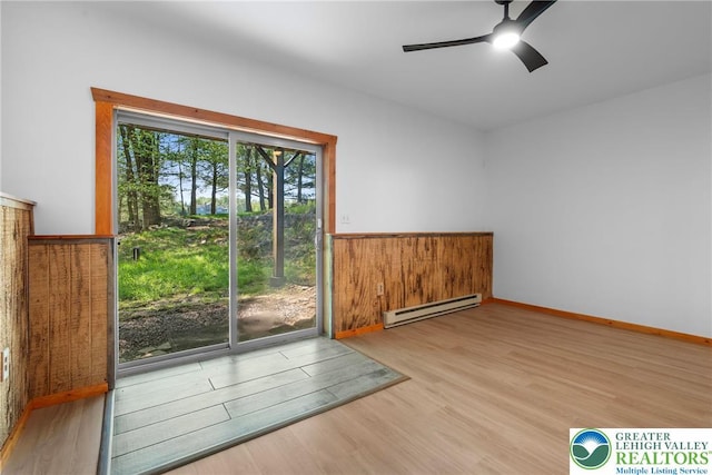 2107 Lenape Ter, Barrett Twp, PA 18325 - empty room featuring baseboard heating, wood finished floors, and ceiling fan