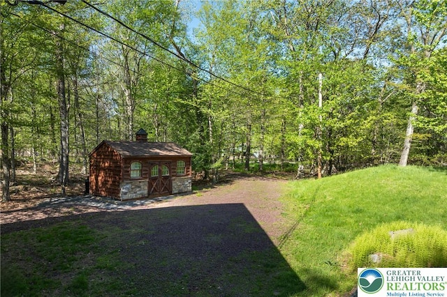2107 Lenape Ter, Barrett Twp, PA 18325 - view of yard with an outdoor structure and a view of trees