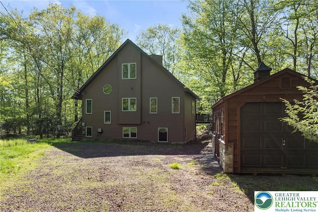 2107 Lenape Ter, Barrett Twp, PA 18325 - view of property exterior featuring an outdoor structure and a garage