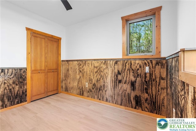 2107 Lenape Ter, Barrett Twp, PA 18325 - empty room featuring a wainscoted wall, wood finished floors, and a ceiling fan