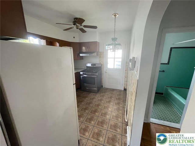 1123 Cumberland Rd, Abington, PA 19001 - kitchen with stainless steel gas range oven, freestanding refrigerator, a ceiling fan, under cabinet range hood, and pendant lighting