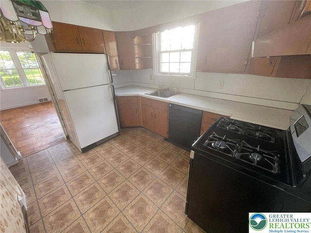 1123 Cumberland Rd, Abington, PA 19001 - kitchen with black appliances, a sink, light countertops, and healthy amount of natural light