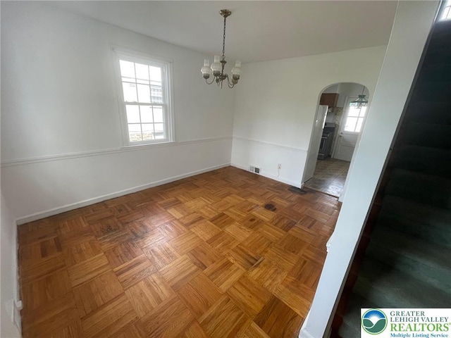 1123 Cumberland Rd, Abington, PA 19001 - unfurnished room with arched walkways, healthy amount of natural light, a chandelier, and baseboards