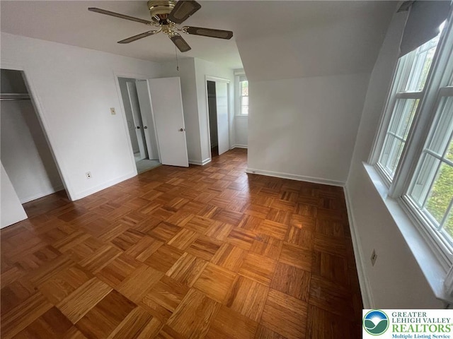 1123 Cumberland Rd, Abington, PA 19001 - unfurnished bedroom with multiple windows, baseboards, ceiling fan, and two closets
