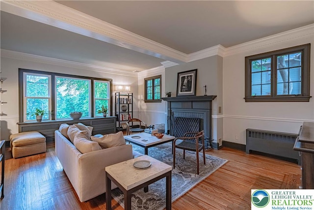 306 W Paxinosa Rd, Forks Twp, PA 18040 - living room featuring radiator, ornamental molding, a fireplace, and wood finished floors