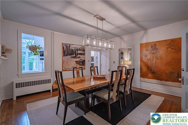 306 W Paxinosa Rd, Forks Twp, PA 18040 - dining room featuring radiator heating unit, wood finished floors, a chandelier, and ornamental molding