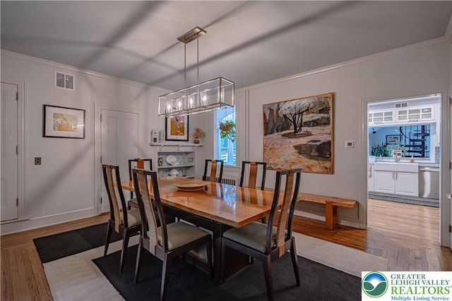 306 W Paxinosa Rd, Forks Twp, PA 18040 - dining room with a chandelier, wood finished floors, ornamental molding, and baseboards