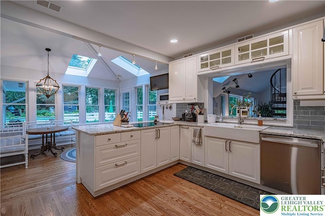 306 W Paxinosa Rd, Forks Twp, PA 18040 - kitchen featuring dishwasher, a skylight, a sink, black electric stovetop, and glass insert cabinets