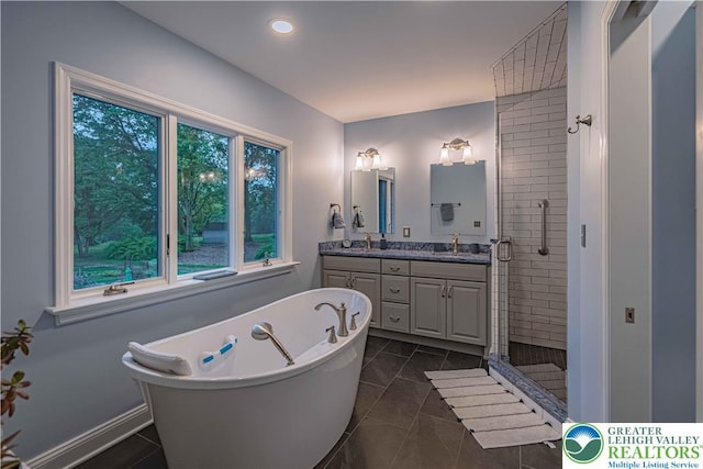 306 W Paxinosa Rd, Forks Twp, PA 18040 - full bathroom with double vanity, a shower stall, a freestanding bath, baseboards, and recessed lighting