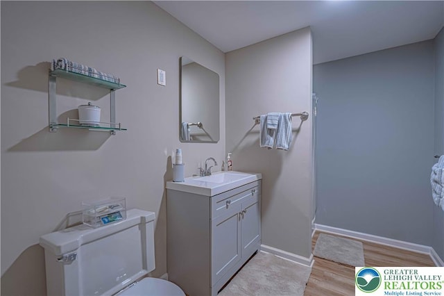 306 W Paxinosa Rd, Forks Twp, PA 18040 - full bathroom with toilet, wood finished floors, vanity, and baseboards