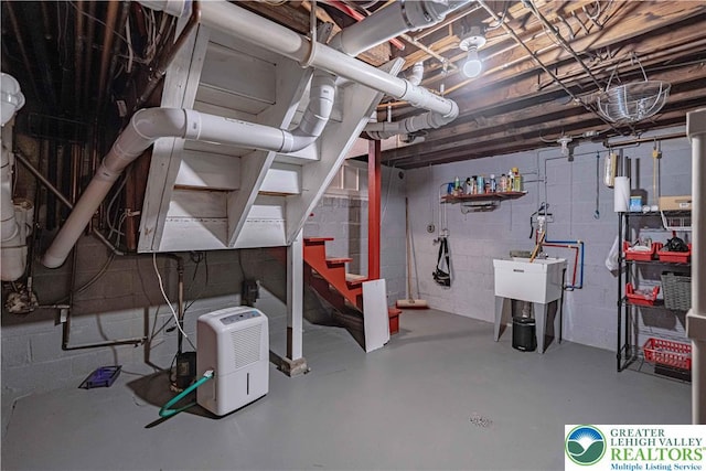 306 W Paxinosa Rd, Forks Twp, PA 18040 - unfinished basement featuring concrete block wall, stairway, and a sink