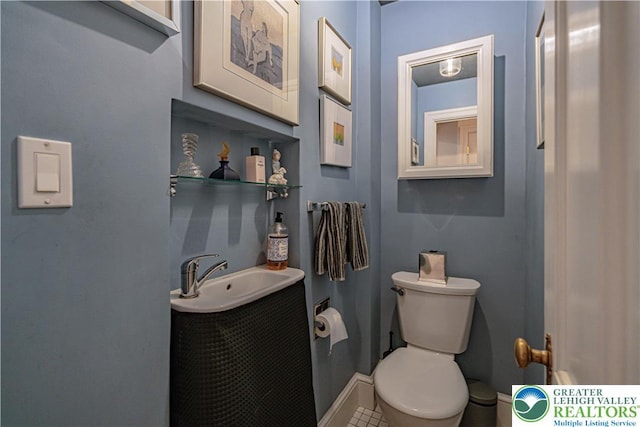 306 W Paxinosa Rd, Forks Twp, PA 18040 - bathroom featuring toilet, a sink, and baseboards