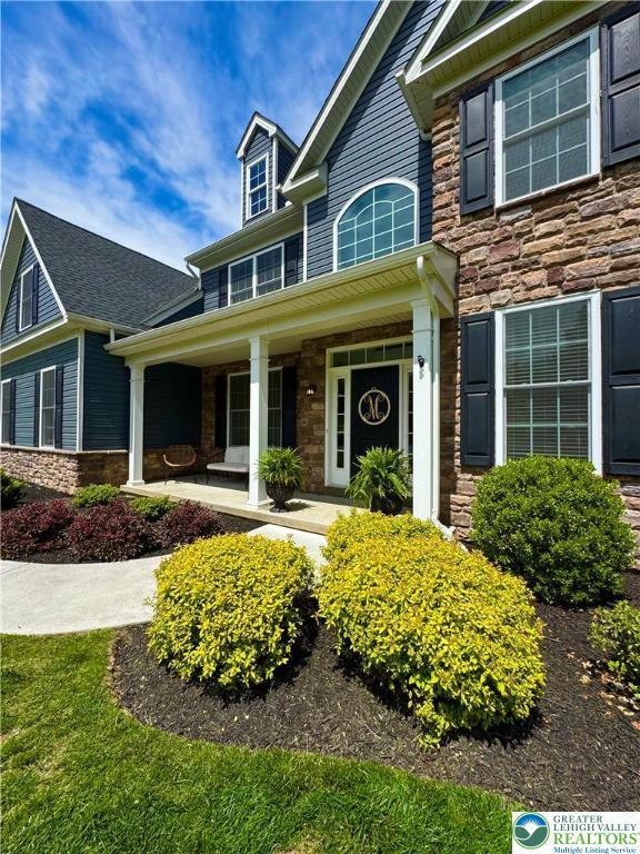 3183 Sheffield Dr, Lower Macungie Twp, PA 18049 - traditional home with stone siding and covered porch