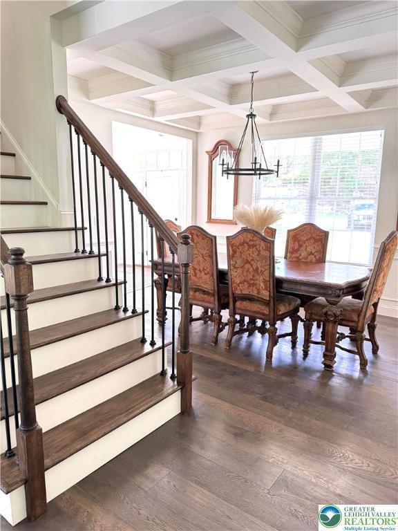 3183 Sheffield Dr, Lower Macungie Twp, PA 18049 - dining room featuring stairs, coffered ceiling, beamed ceiling, a chandelier, and dark wood finished floors