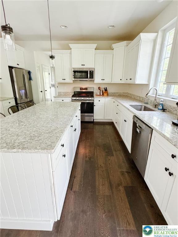 3183 Sheffield Dr, Lower Macungie Twp, PA 18049 - kitchen with stainless steel appliances, a sink, dark wood-type flooring, light stone countertops, and white cabinets