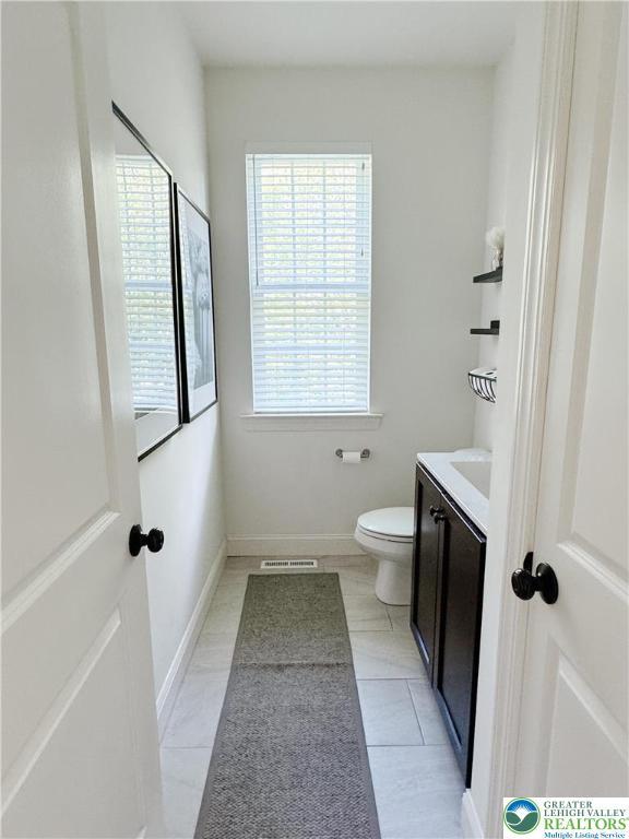 3183 Sheffield Dr, Lower Macungie Twp, PA 18049 - bathroom with toilet, vanity, and tile patterned floors
