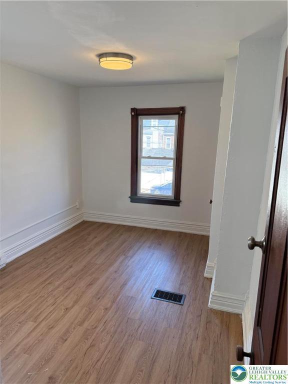 617 N 9th St, Allentown City, PA 18102 - empty room featuring wood finished floors and baseboards