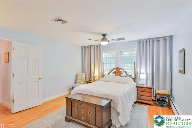 113 S Fairview St, Macungie Borough, PA 18062 - bedroom with a baseboard heating unit, light wood-type flooring, a ceiling fan, and baseboards