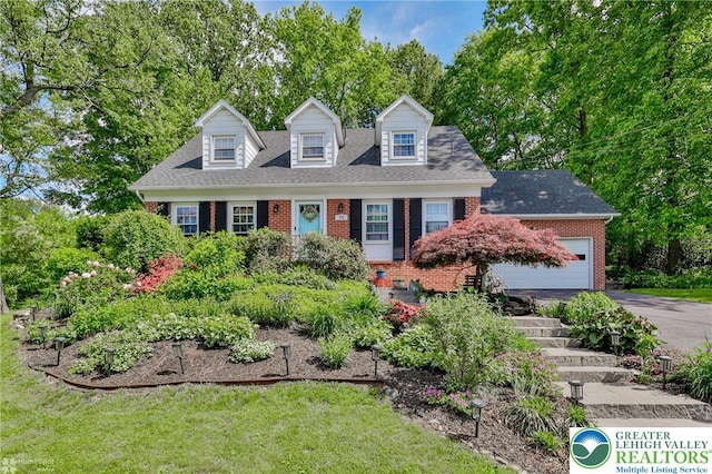 113 S Fairview St, Macungie Borough, PA 18062 - new england style home with brick siding, asphalt driveway, an attached garage, and view of wooded area