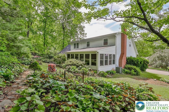 113 S Fairview St, Macungie Borough, PA 18062 - back of property with a chimney, a sunroom, and central AC unit